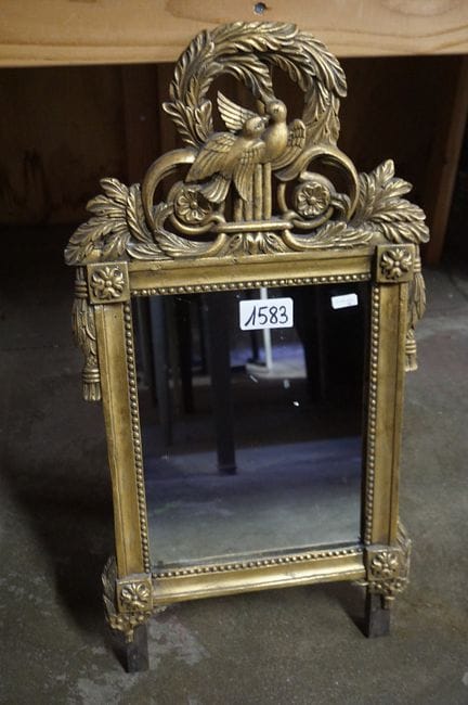 Beautiful gilded mirror—decorated with birds at th