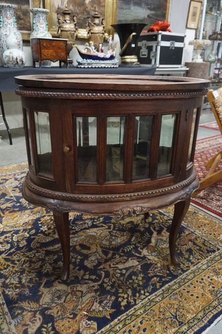 Oval bar cabinet in mahogany color—with 2 doors—wi