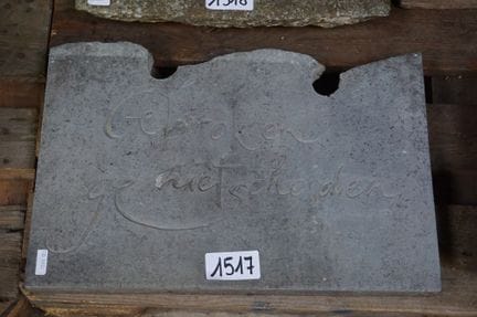 Blue stone sculpture—with the inscription "BROKEN 