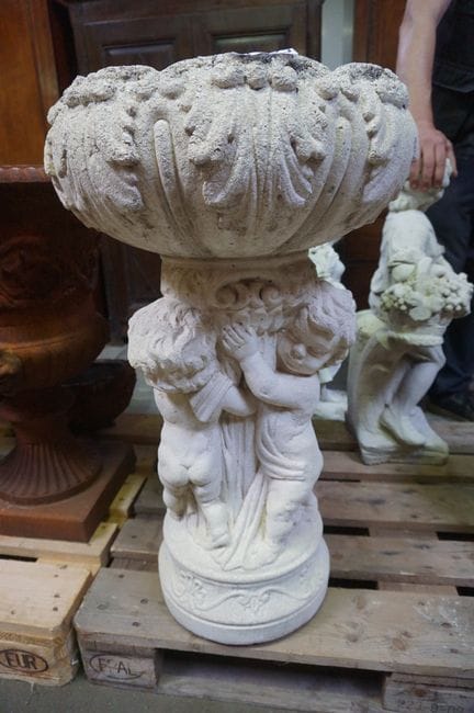 Large concrete garden jardinière—supported by thre