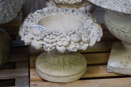 concrete garden statue—decorated with fruit in rel
