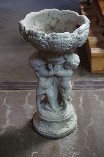 Concrete garden jardinière—supported by 3 putti—H: