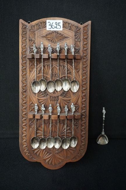 12 apostle spoons with a carved wooden wall rack -
