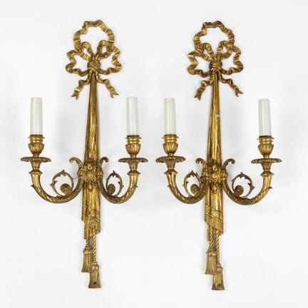 Coppia di applique con motivo a fiocco, bronzo dor