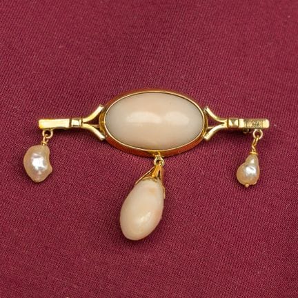 An antique brooch set with two natural stones and 