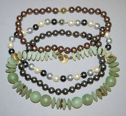 Three coloured cultured pearl necklaces, gold & ja