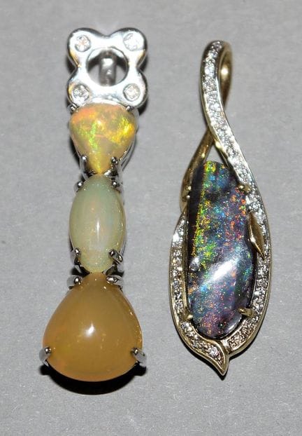 Two pendants with opals, one featuring an Amayani,