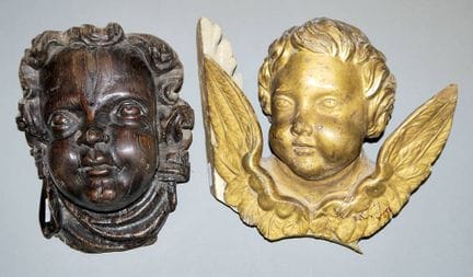 Two large Baroque putto heads in gold and black, S
