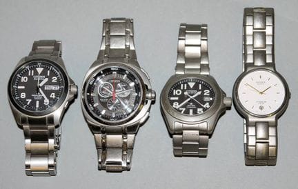 Four HAU Citizen Titanium watches, including three
