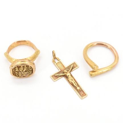 2 anillos y una cruz de oro amarillo de 14 quilate