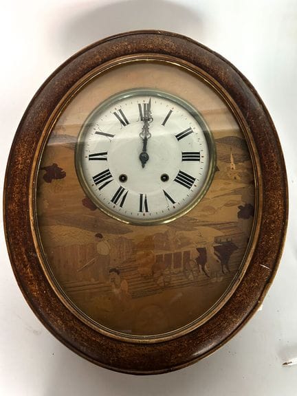 Pendule d'applique de forme ovale en bois de placa