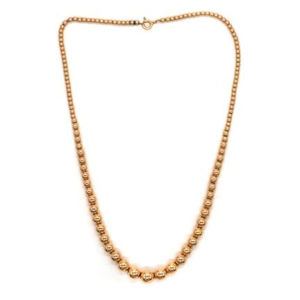COLLIER à boules graduées or jaune 18K. 
Poids : 1