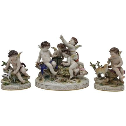 "Cherub Figures" A set of three polychrome porcela