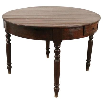 Round fir table with side drawers and carved legs.