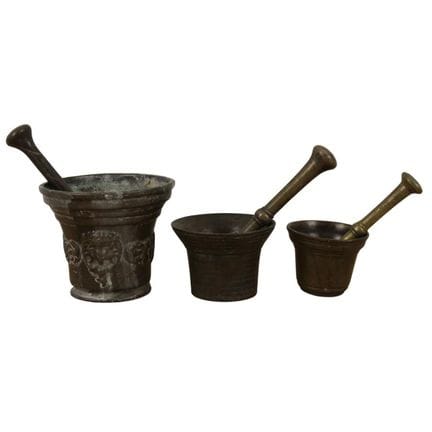 Trois mortiers en bronze. L'un des trois est décor
