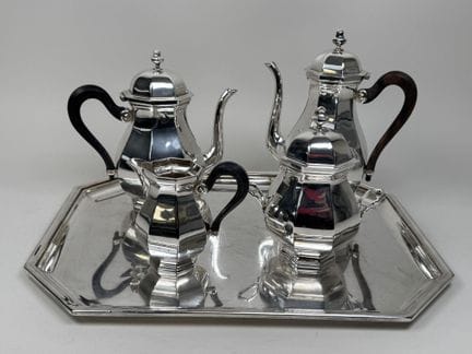 A silver plated coffee and tea set with beveled ed
