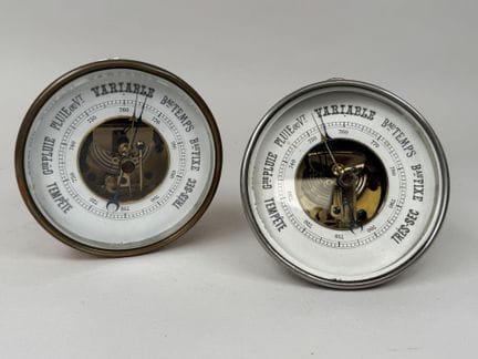 Two circular barometers made of metal and brass, w