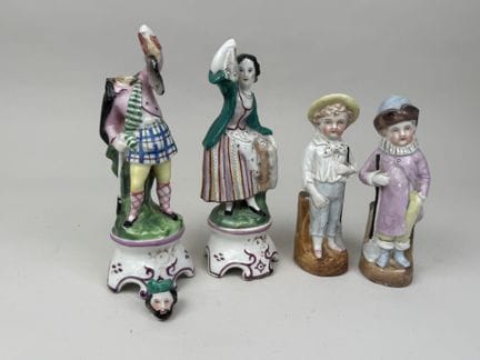 A pair of polychrome and gold porcelain match hold