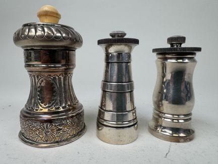 3 small silver-plated metal pepper mills, 2 of whi