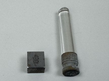 Glass seal; the metal die is engraved with a numbe