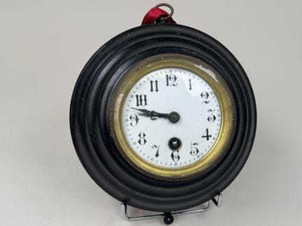 Circular wall clock made of sheet metal, with a br