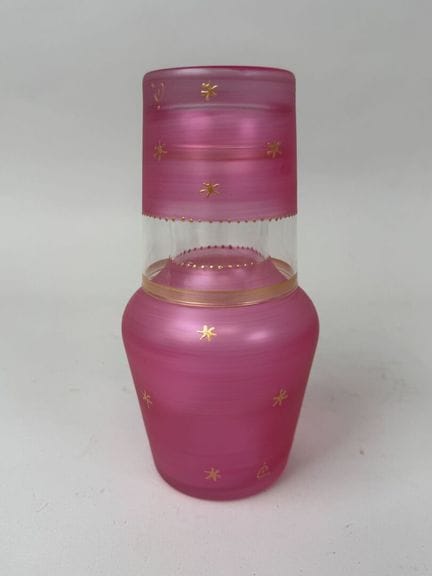 A pink-tinted glass night set accented with gold a