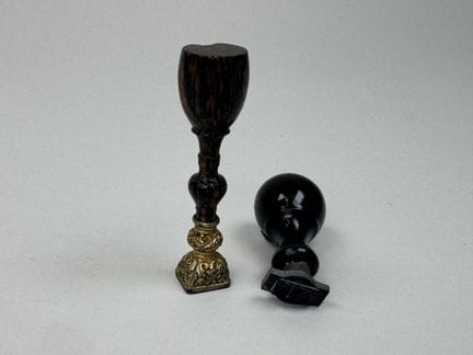 Turned wooden seal; the gold-plated metal die feat
