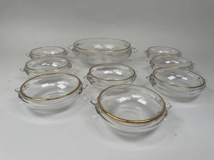A cream serving set made of molded glass with gold