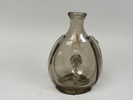 Colored, hand-blown glass bottle with applied deco