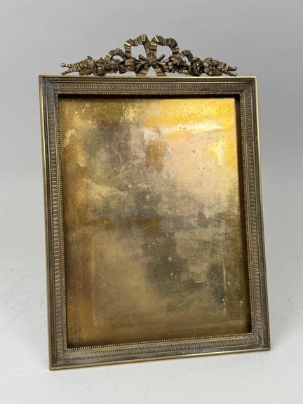 A large, gilded and chiseled bronze picture frame 
