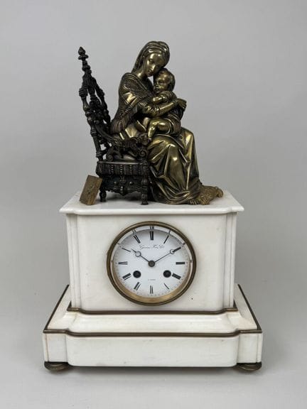 A patinated and gilded bronze clock depicting a se