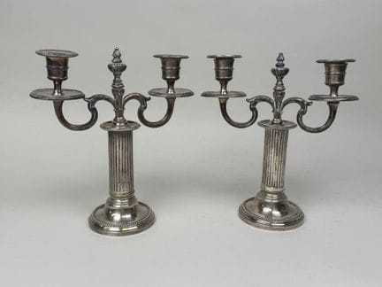 Pair of two-armed silver plated candlesticks with 