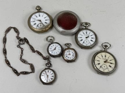 Two pocket watches and two silver wristwatches. 
I