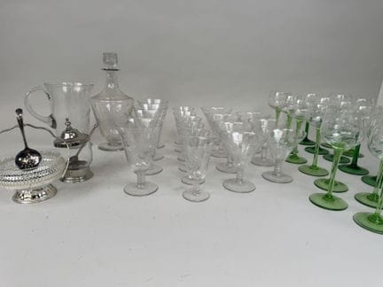 A set of glassware featuring an engraved design of