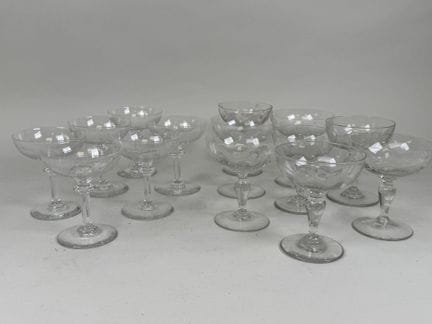 Two sets of crystal and engraved glass champagne f