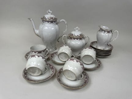 A polychrome and gold porcelain coffee set decorat