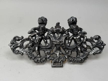 Metal piece with a silvery patina, decorated with 