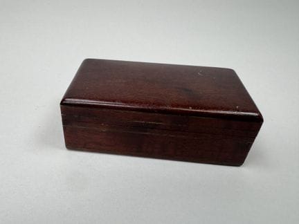 Small rectangular stamp box made of wood and brass
