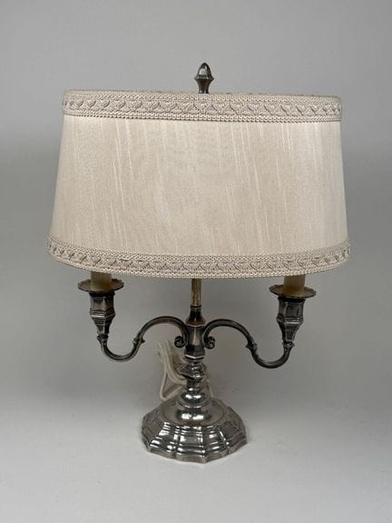 A silver plated metal candelabrum with two arms an