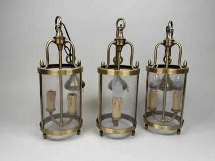 Three circular lanterns made of gilded metal and g