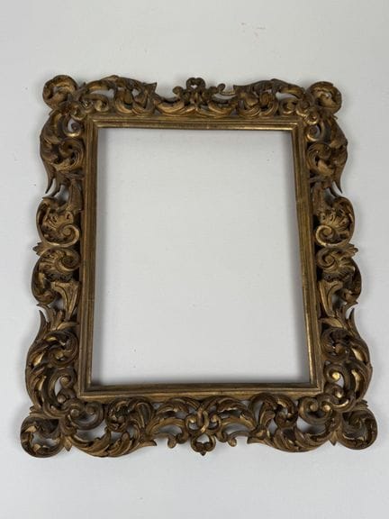 Carved, gilded, and openwork wooden frame with a f