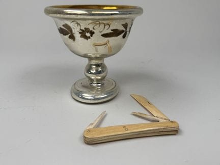 A glass goblet with an églomisé finish, decorated 