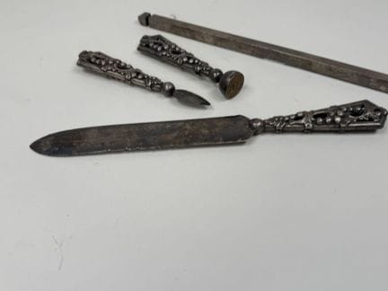 A desk set made of chiseled and openwork metal, de