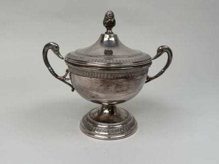 Silver plated sugar bowl with a lid, featuring two
