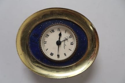 CARTIER.
Orologio da viaggio ovale in metallo dora