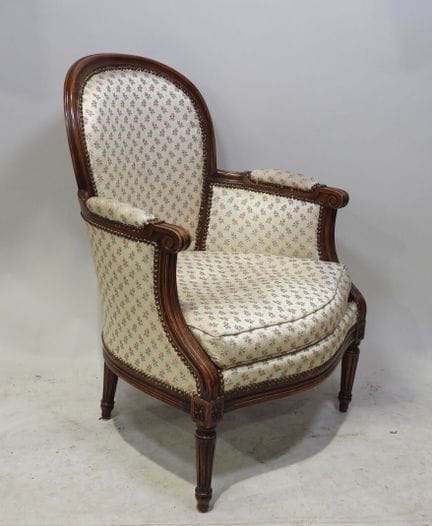 Sillón bergère de madera moldeada, con respaldo en