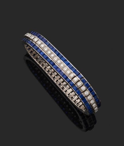 18K白金（750‰）铰接式手链，两排规格统一的蓝宝石之间，镶嵌着一排共五十四颗圆形明亮式切割钻石，