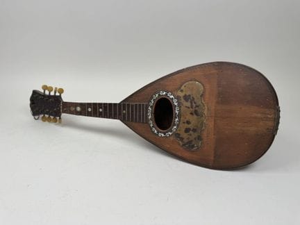 Wooden mandolin.
Bears a label reading "FRATELLI T