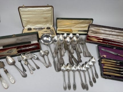 A large set of table cutlery, a ladle, and a set o