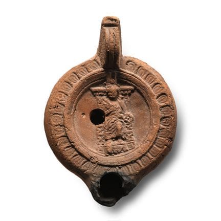 Lampada a olio romana in terracotta con figura e m